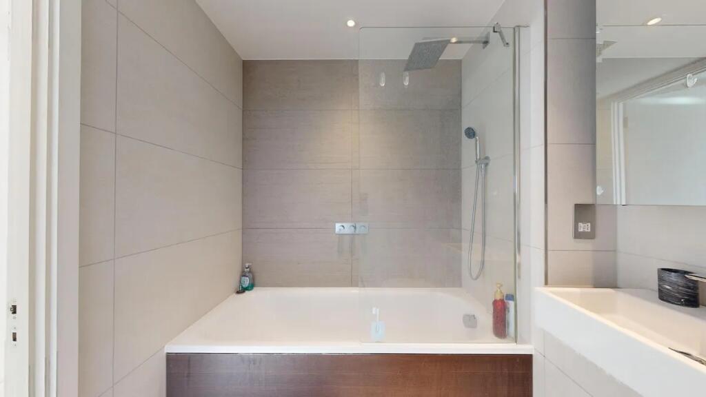 A modern bathroom suite featuring a large batht...