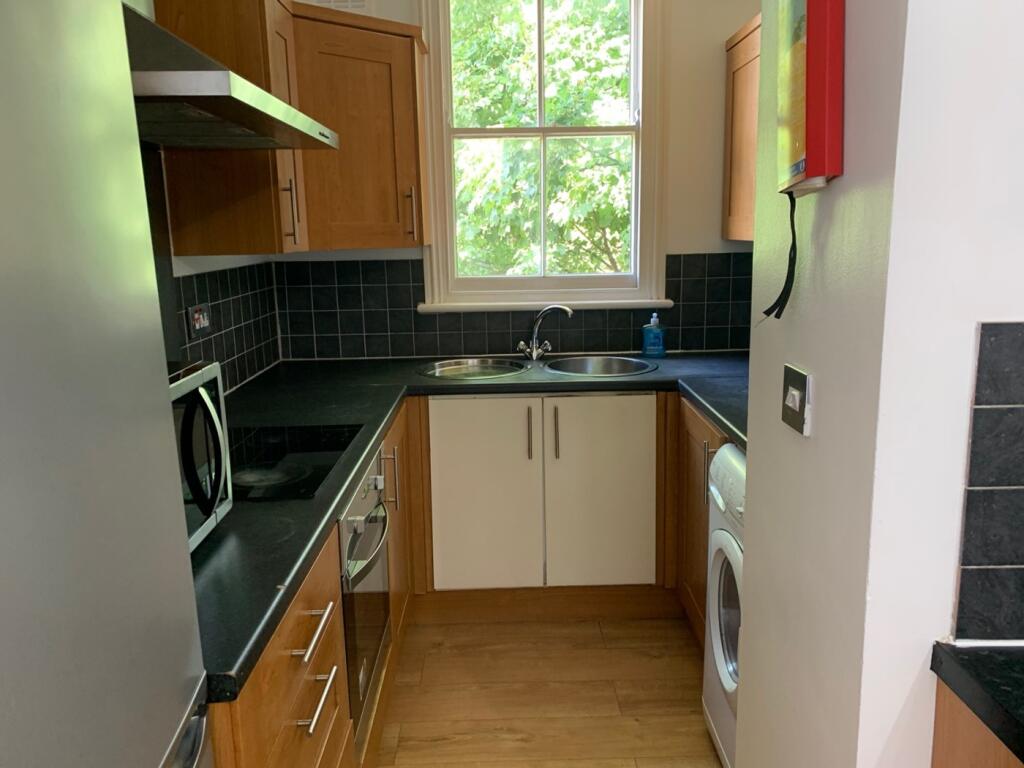 A bright and tidy kitchenette with modern appli...