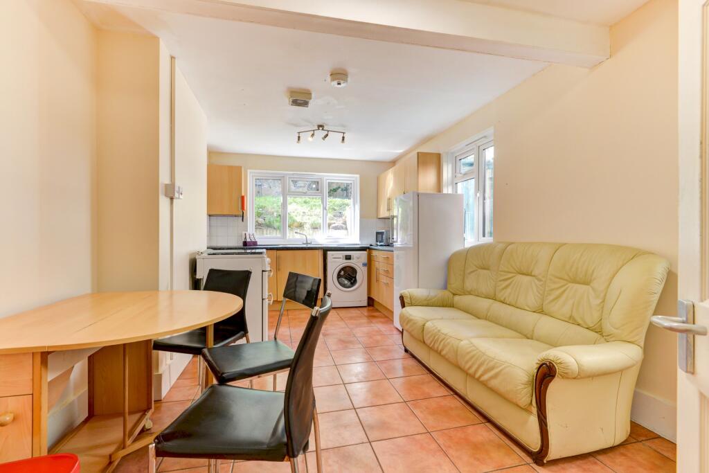 A bright and inviting living area with a cozy c...