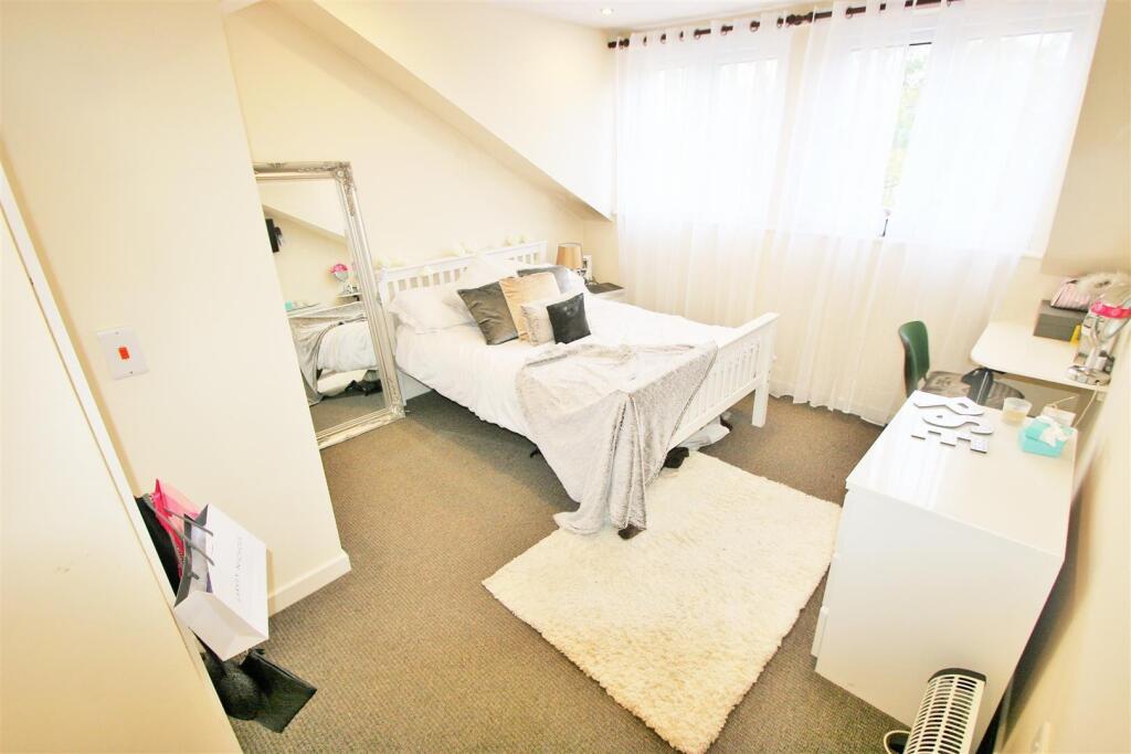 A bright and welcoming double bedroom featuring...