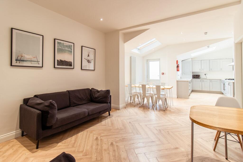 A bright and spacious living area featuring a c...