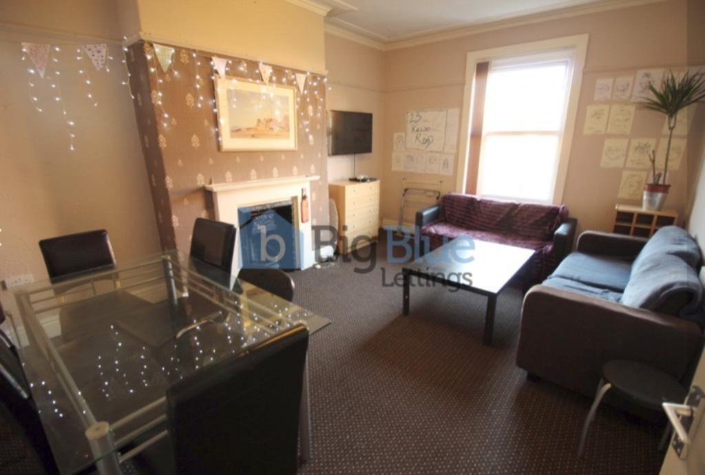 A bright and welcoming living room featuring co...