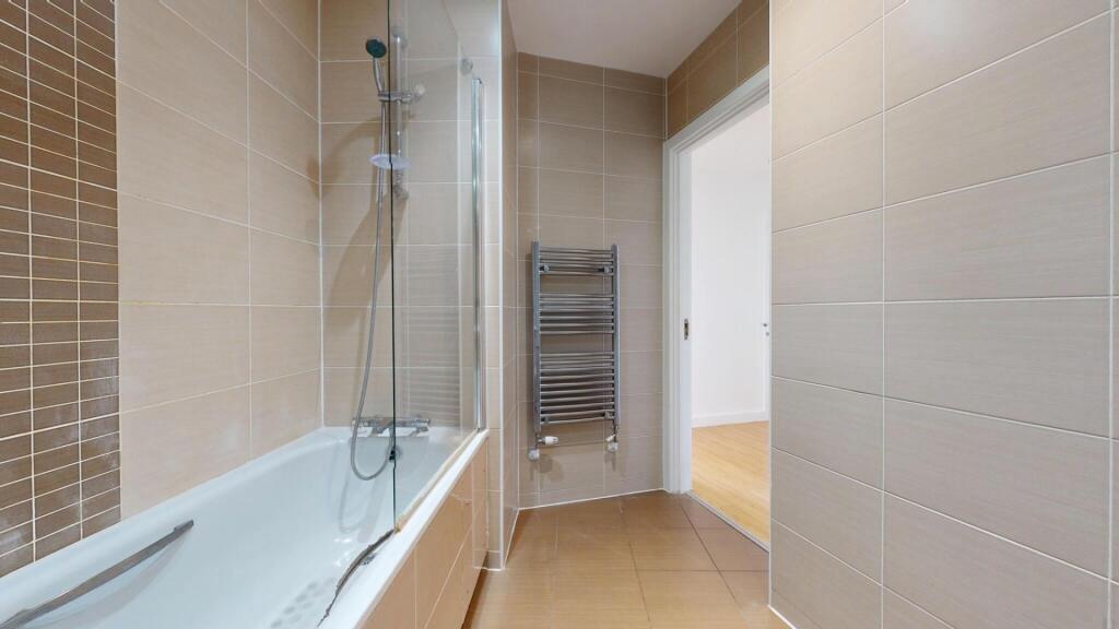 A modern and well-maintained bathroom suite fea...