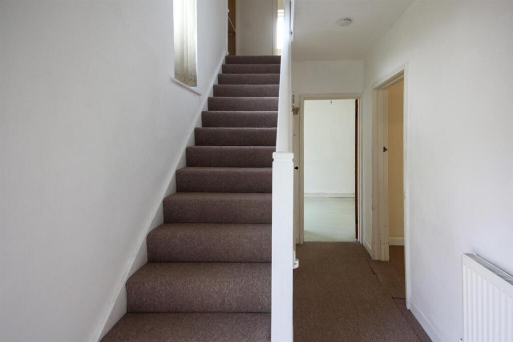 Stairs rising to the first floor