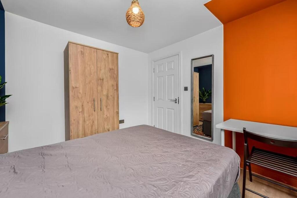 A bright and welcoming double bedroom featuring...