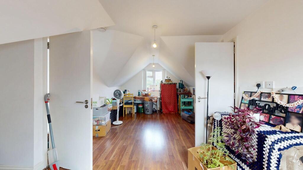Bright and clean single toilet room with wooden...