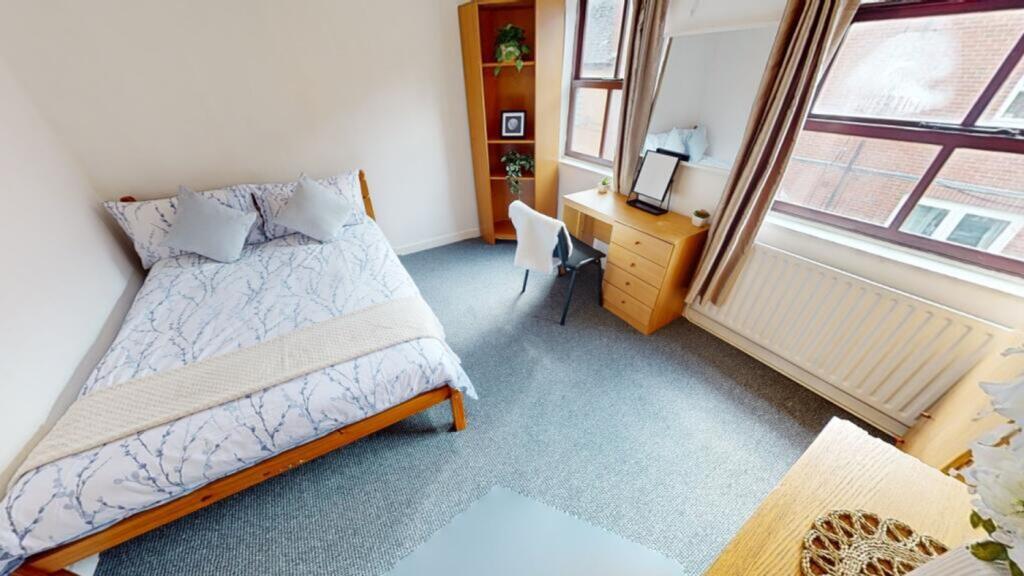 A bright and inviting double bedroom featuring ...