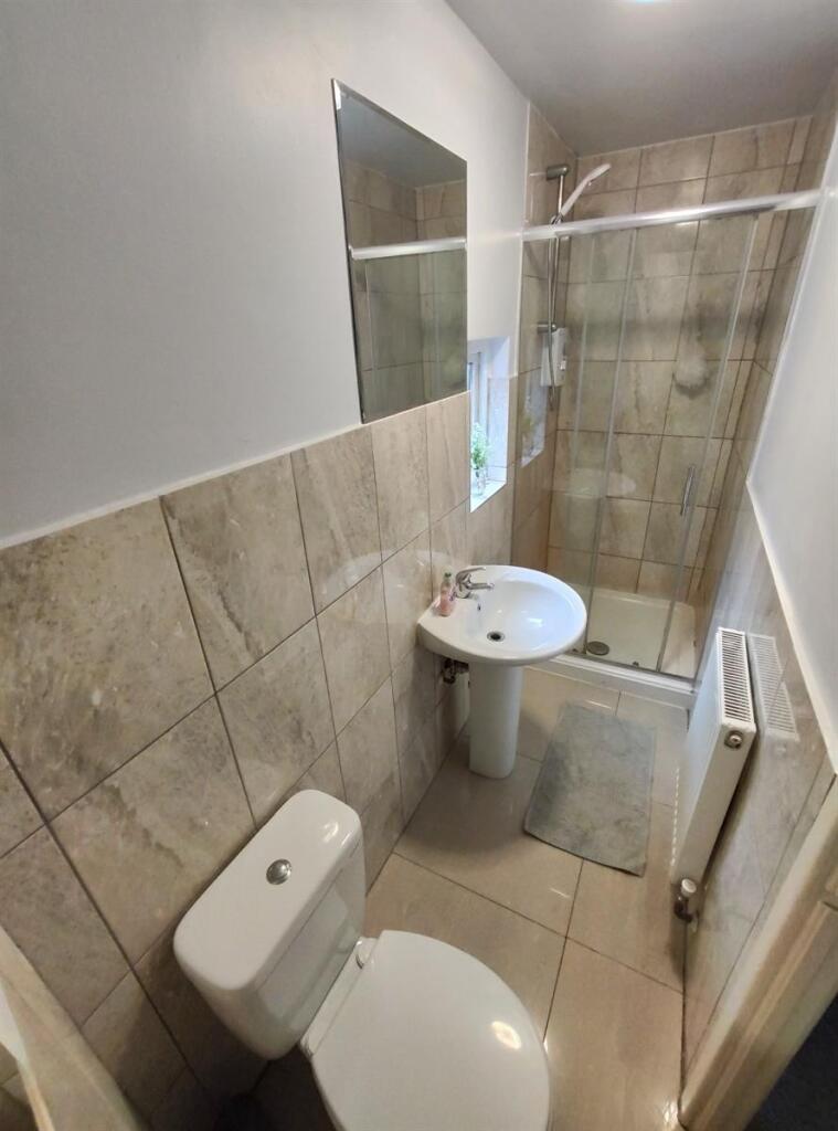 Bright and clean bathroom featuring modern tile...