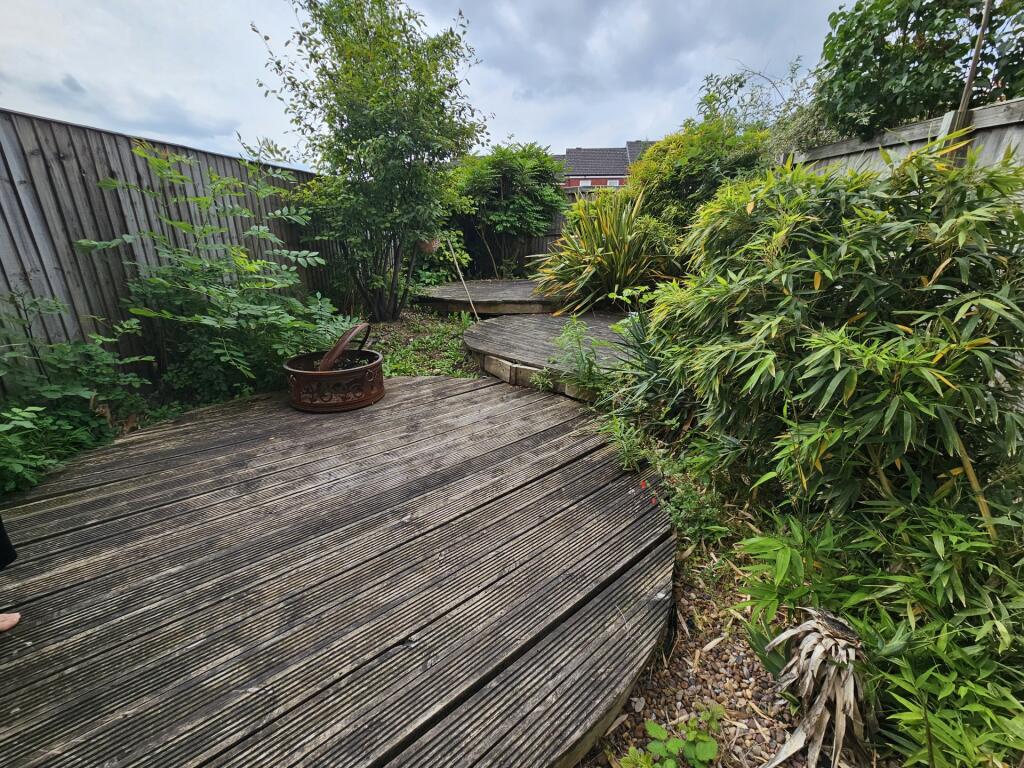 A charming garden space featuring tiered wooden...