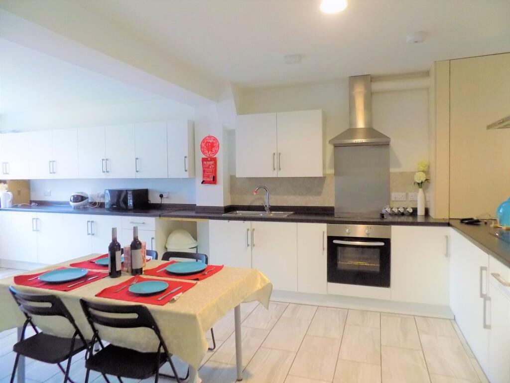 Bright and modern kitchen featuring ample white...