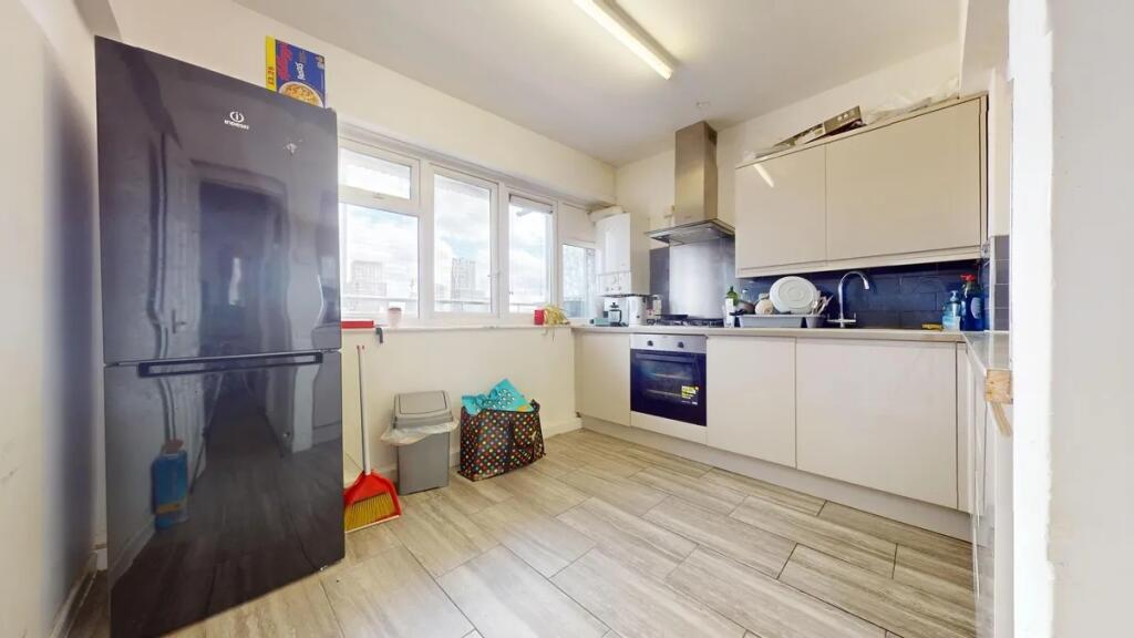Bright, modern kitchen featuring sleek cabinetr...