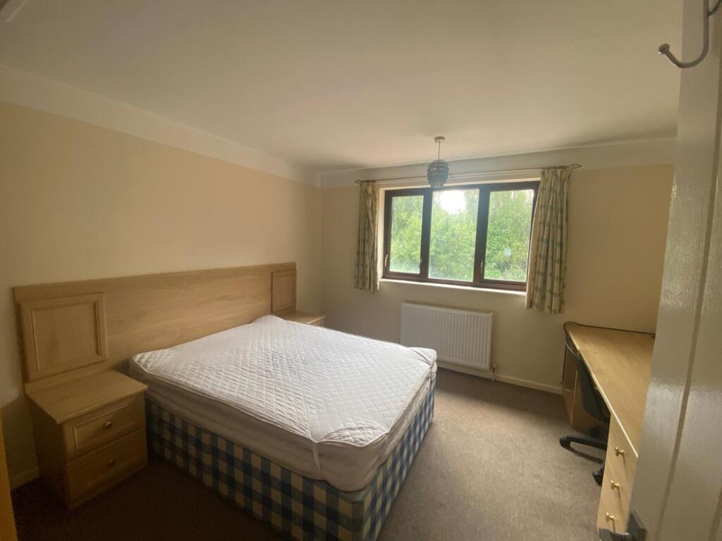 Spacious double bedroom featuring a comfortable...