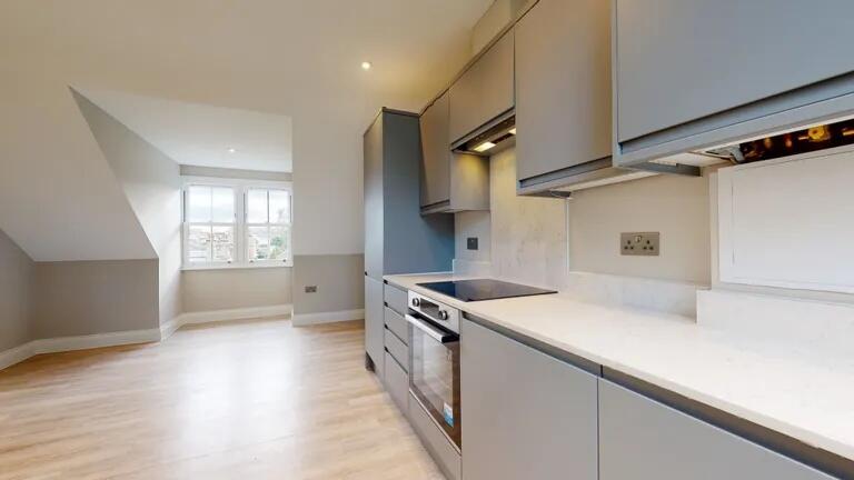 Modern kitchen with sleek grey cabinetry and in...
