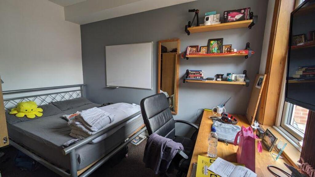 A cozy double bedroom with ample storage and a ...