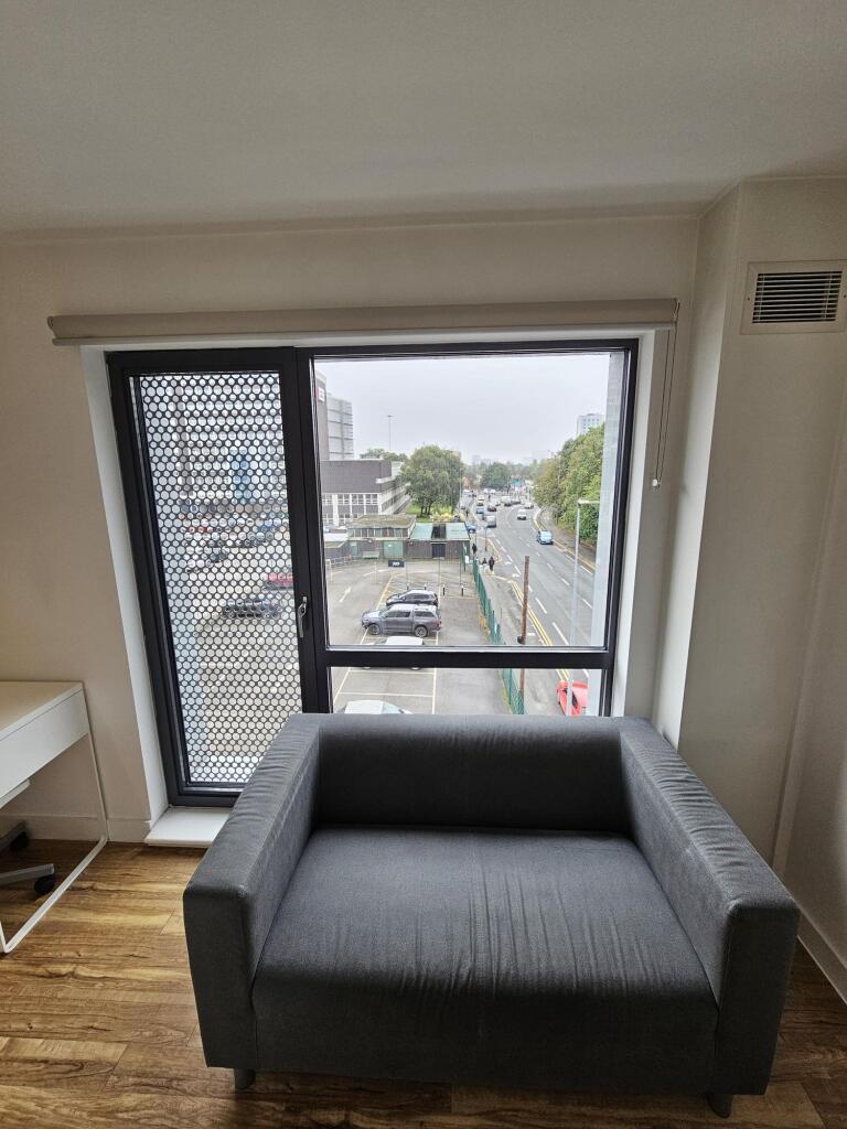 Compact living area featuring a modern armchair...