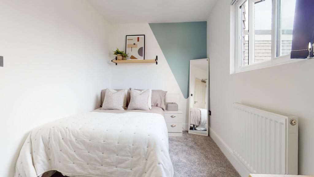 A bright and inviting double bedroom featuring ...