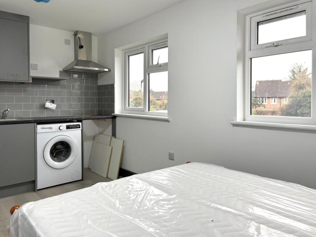 Bright, simply styled bedroom with fresh neutra...