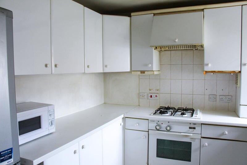 Bright kitchen with ample white cabinetry and a...