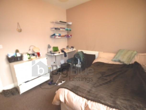 Cozy double bedroom featuring a comfortable bed...