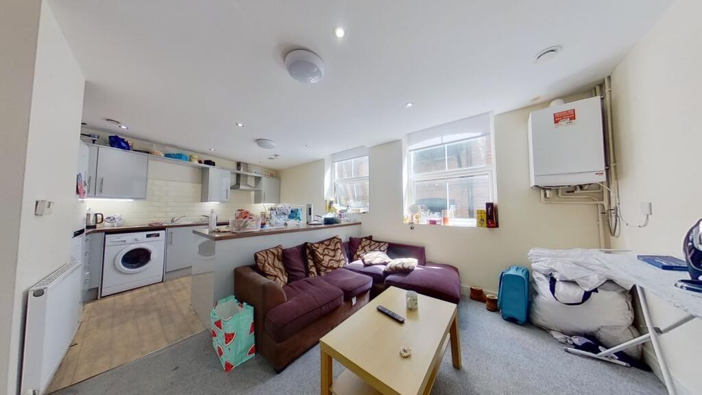 A cozy living room featuring a comfortable brow...