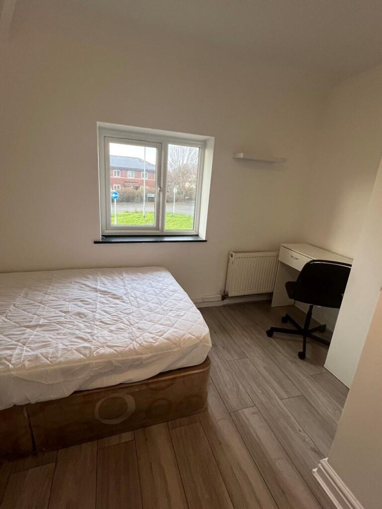 A bright and tidy double bedroom featuring a co...