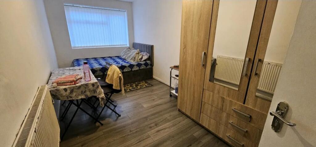 Cozy double bedroom featuring a comfortable bed...