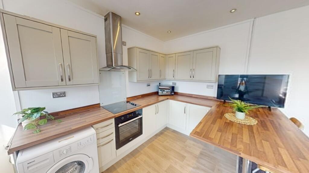 Bright and modern kitchen featuring light cabin...