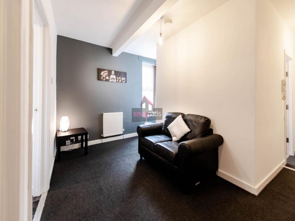 A cozy living room featuring a comfortable blac...