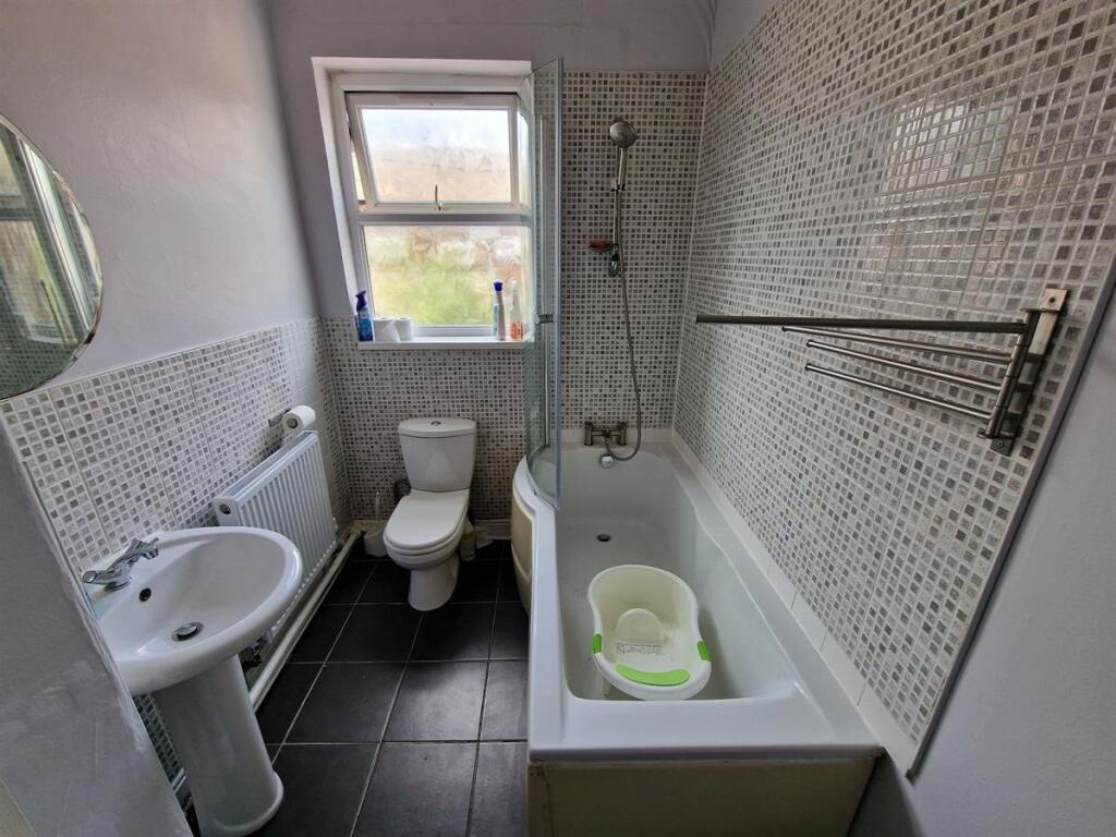 A clean and modern bathroom featuring a full ba...