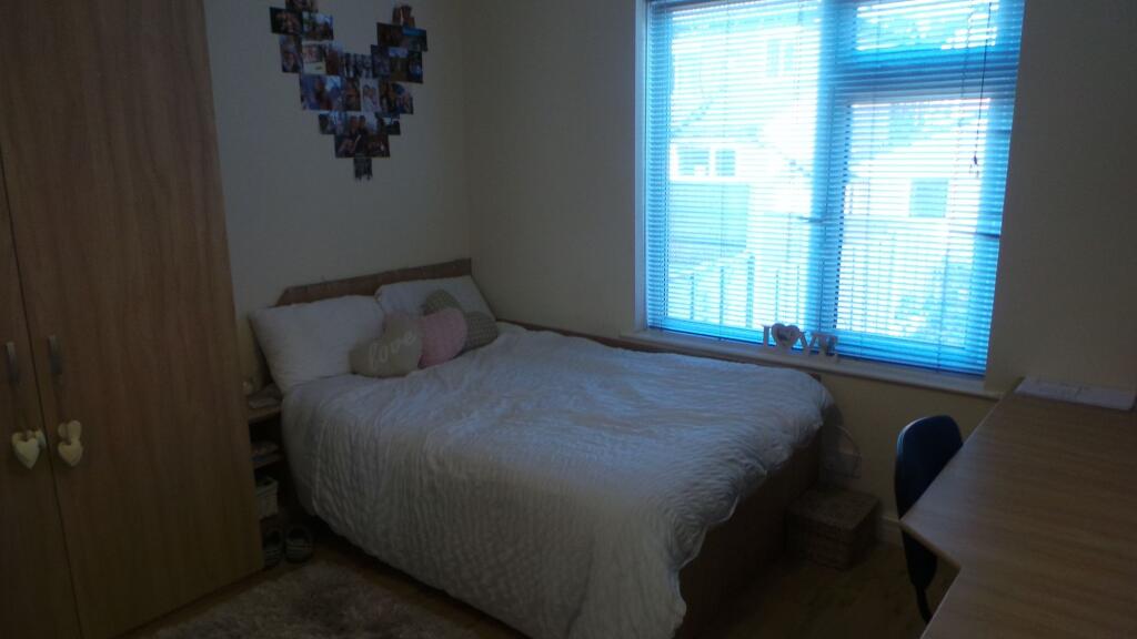 A cozy bedroom featuring a double bed with deco...