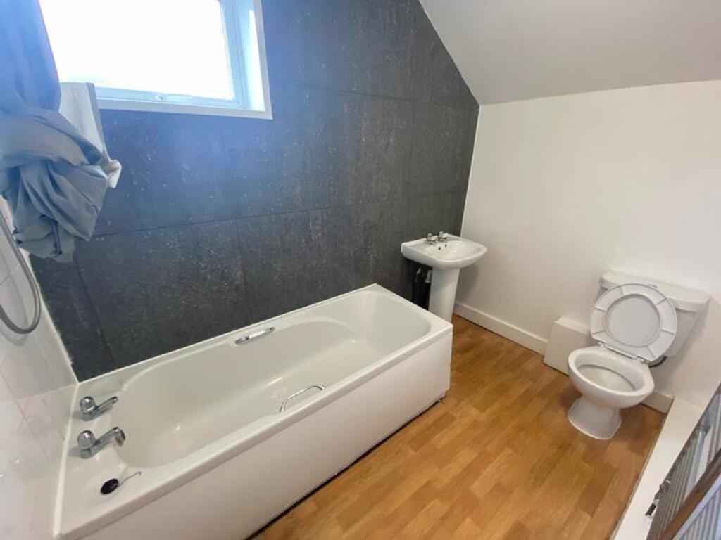 A bright and modern bathroom featuring a stylis...