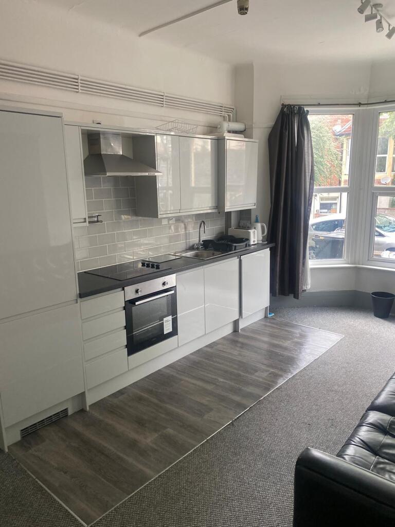 Modern, well-maintained kitchen with sleek whit...