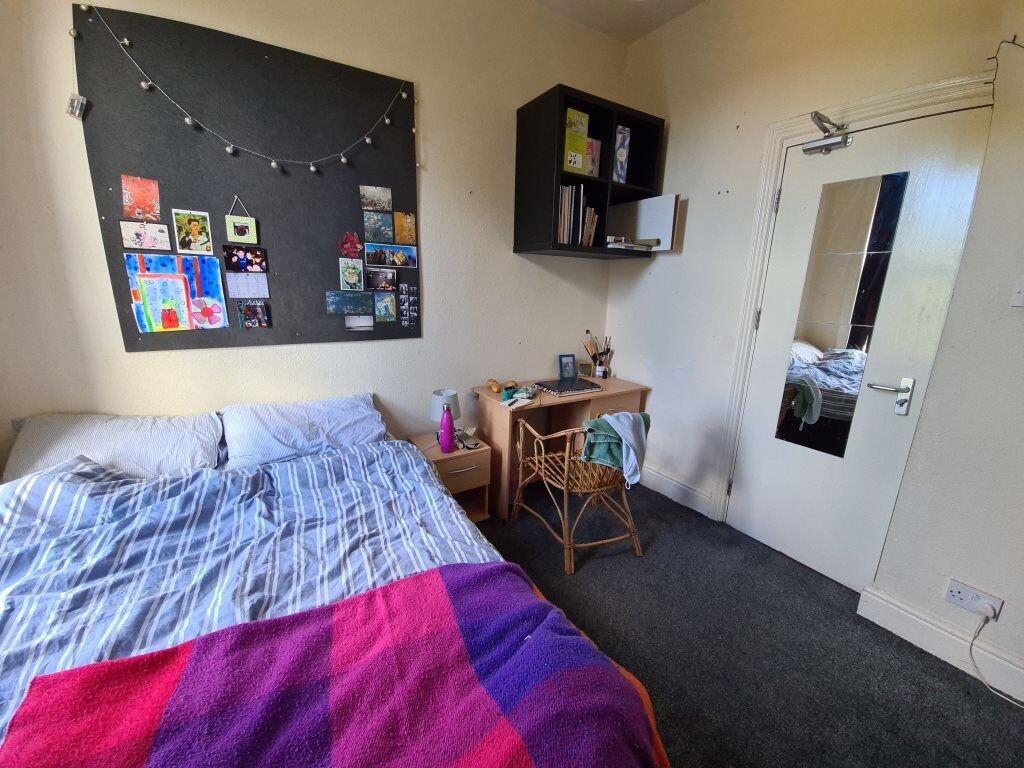 Cozy single bedroom featuring a comfortable bed...
