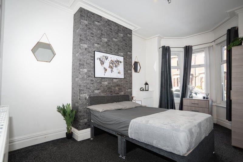 A stylish double bedroom featuring a cozy doubl...