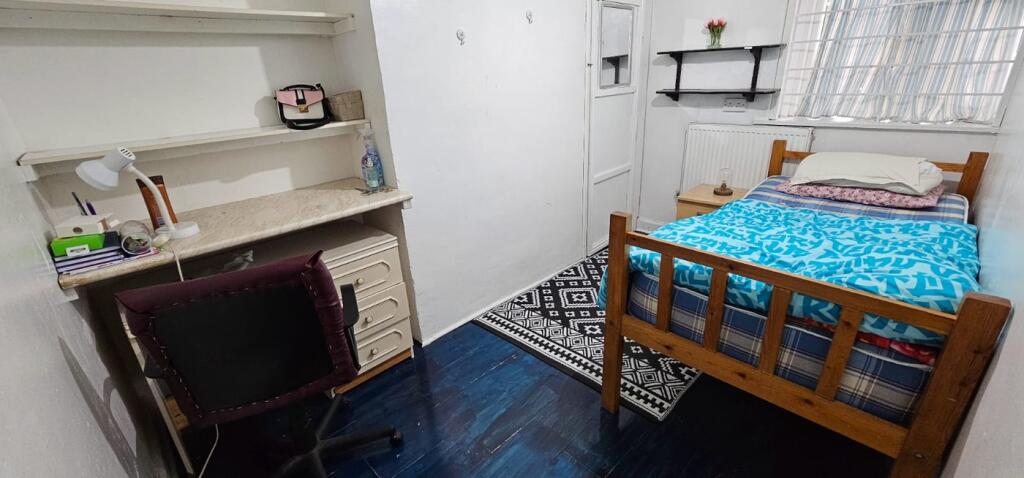 Cozy double bedroom featuring a comfortable bed...