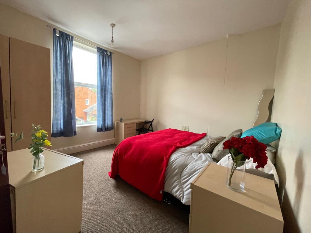 A well-maintained bedroom featuring a single be...