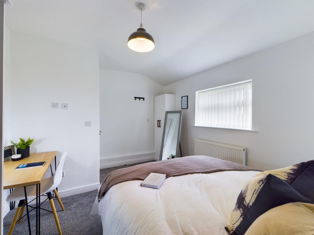 A bright and inviting double bedroom featuring ...