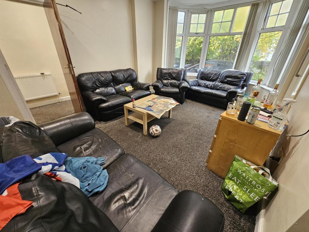 Spacious and welcoming living room with ample s...