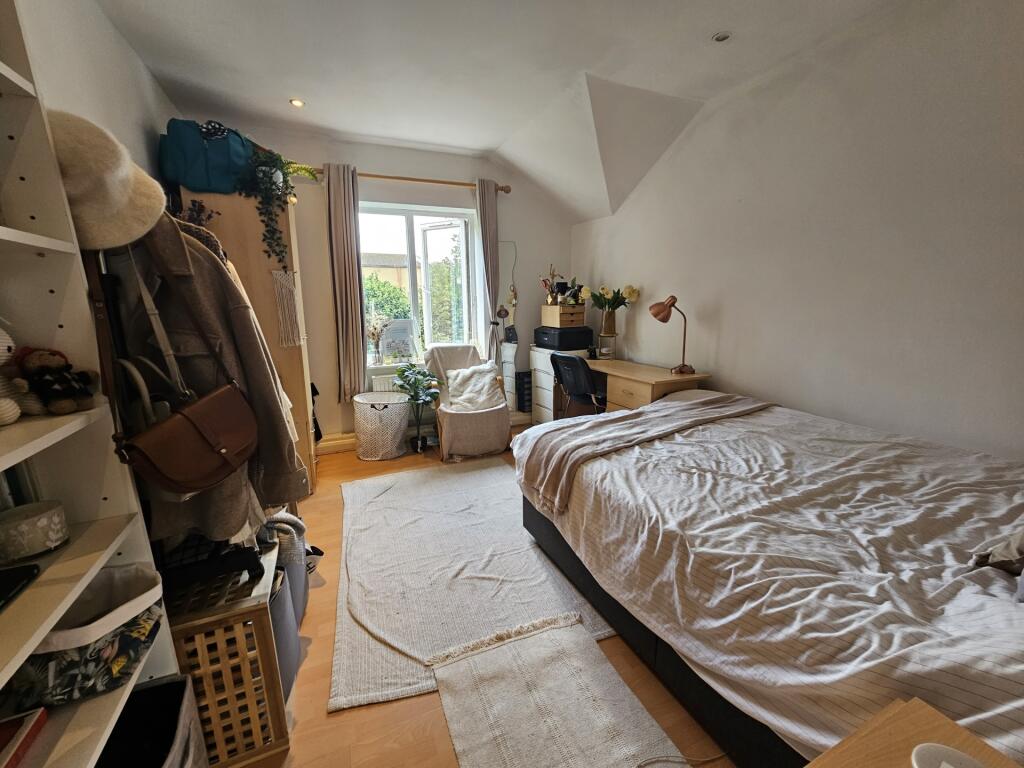 Bright and spacious master bedroom featuring a ...