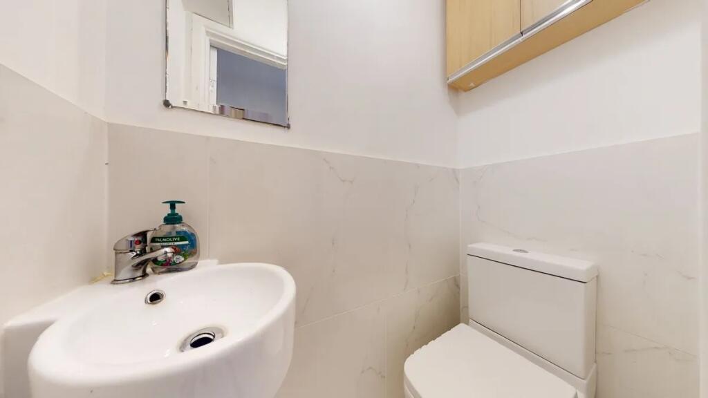 Bright and clean single toilet featuring modern...