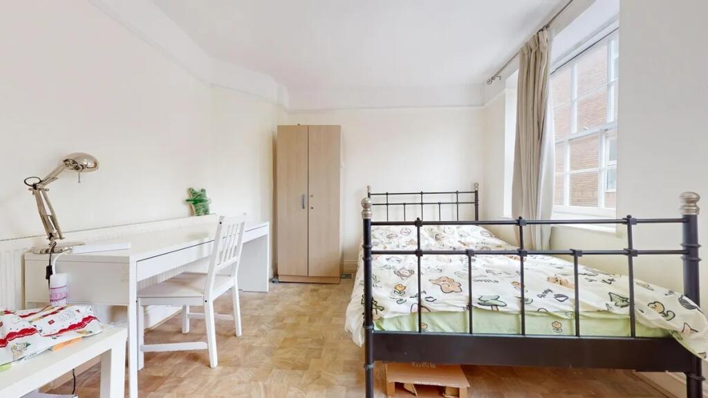 Bright and airy double bedroom with a large win...