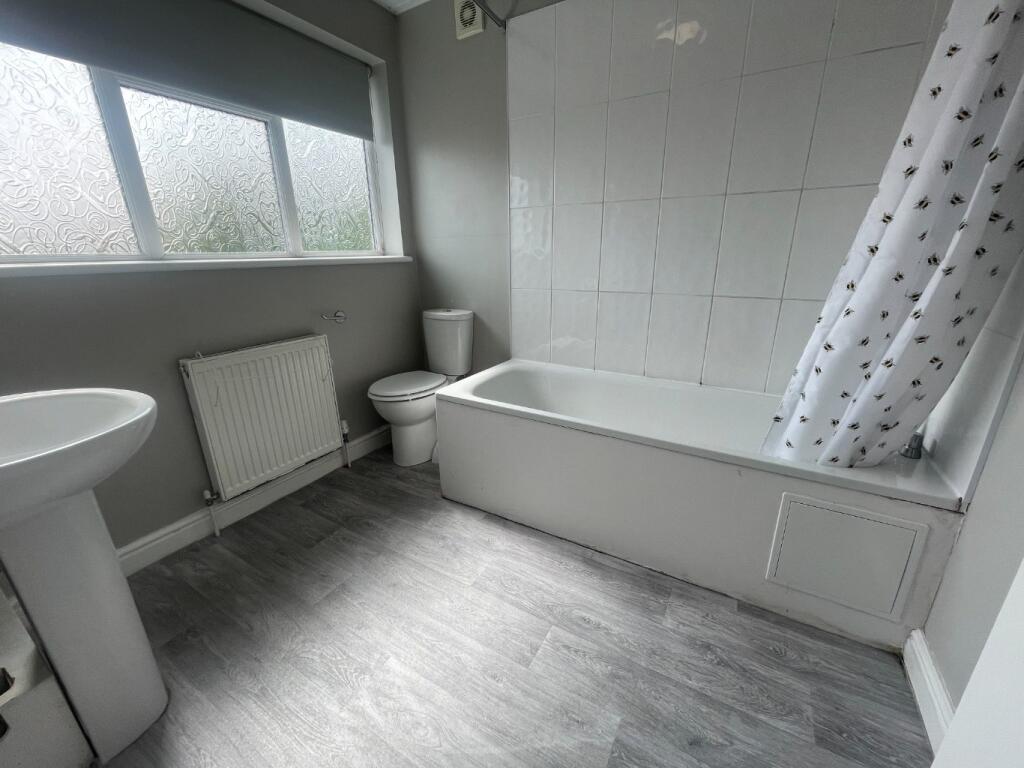 Bright and modern bathroom featuring a spacious...