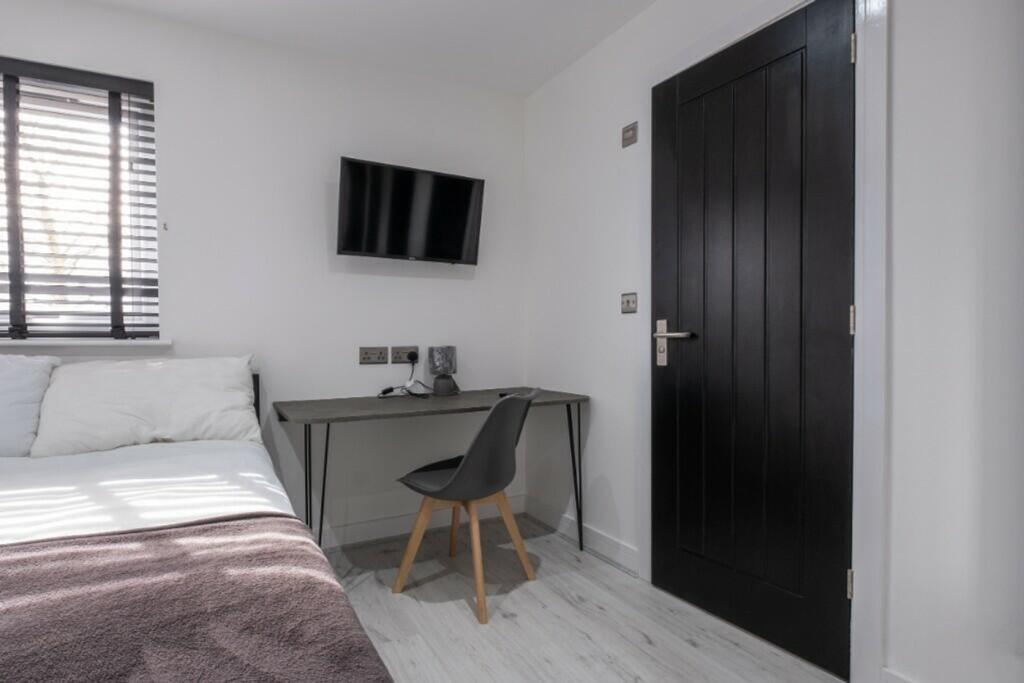 A bright and modern double bedroom featuring a ...