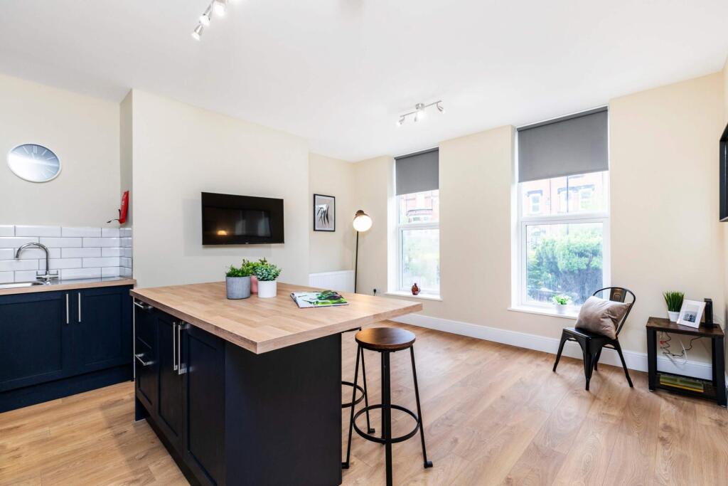 Bright open-plan living area with large windows...