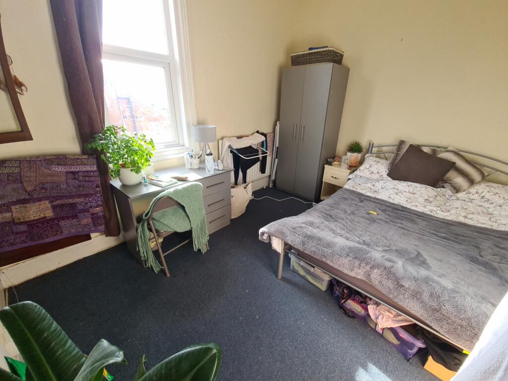 A cozy bedroom with a double bed, natural light...