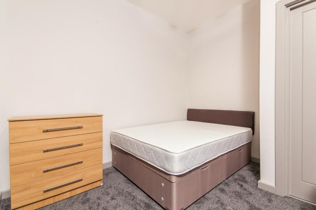 A clean and inviting double bedroom with ample ...
