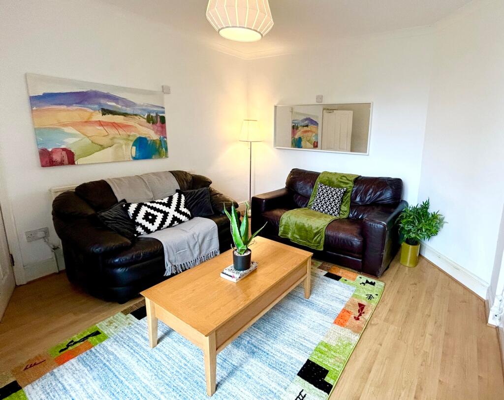 A cozy and inviting living room featuring comfo...