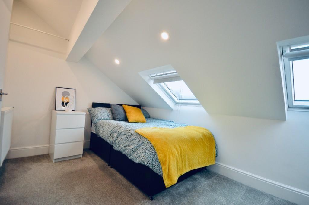 A bright and cozy double bedroom featuring styl...