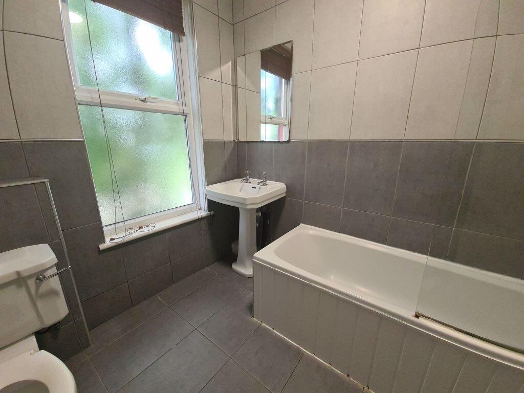A modern bathroom suite with a large bathtub, w...