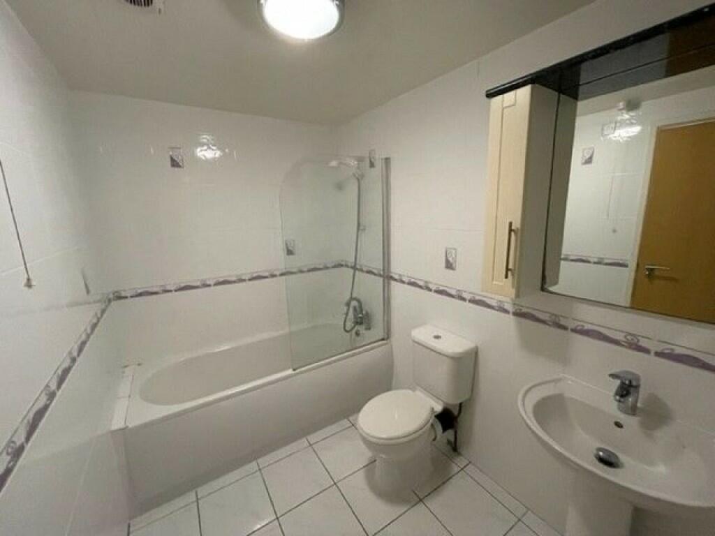Bright and clean bathroom featuring a spacious ...